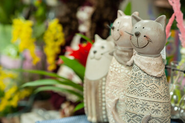 Souvenirs with cats on the shelf in the store. Small business. Selective focus.