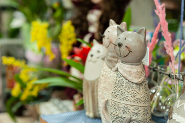 Souvenirs with cats on the shelf in the store. Small business. Selective focus.
