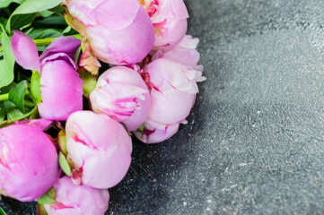 Pink peonies on a grey table