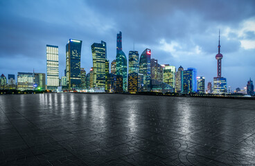 Empty square floor and modern city scenery at night in Shanghai,China.