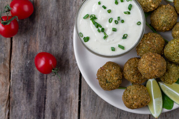 Chickpea falafel balls with sauce and tomatoes