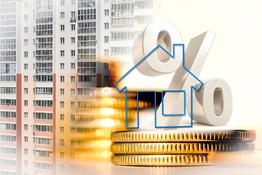 The percent symbol and real estate  on a background of money . The concept of price changes on the real estate market .