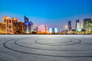 Empty racing track road and hangzhou city night scenery at night,China.