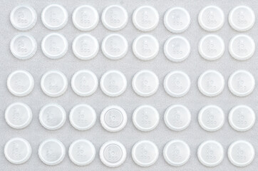 transparent white round caps on a gray background. pattern