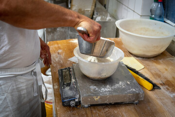 in  bakery a baker mixes the ingredients for a bread dough
