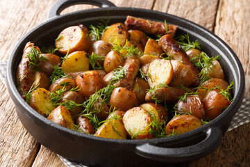 Homemade food new potatoes with sausages and dill closeup in a pan. horizontal