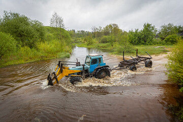 timber tractor crosses the river