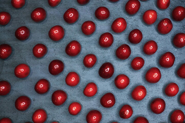 The cherry lies in a row parallel. filmed from above on a black background 
