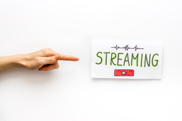 Live streaming web network concept. Female hands holding paper tablet. Top view