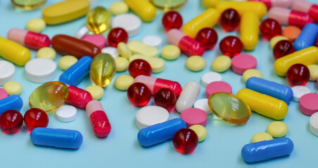 Multi-colored tablets, capsules, vitamins, supplements. Сoncept of treatment and healthcare.