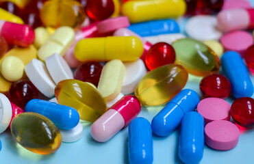 Multi-colored tablets, capsules, vitamins, supplements. Сoncept of treatment and healthcare.