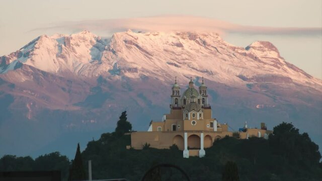 Sunrise Time Lapse of the sanctuary of "nuestra se&ntilde;ora de los remedios" with snowy Iztaccihuatl volcano in Cholula, Mexico.