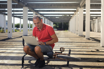 BMX rider on the bike looking at notebook outside on the street, urban style.