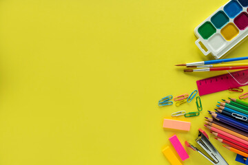 Fototapeta premium School supplies on yellow background. School concept. Top view
