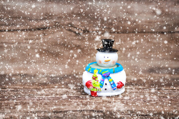 Christmas winter background with snowman in winter christmas landscape