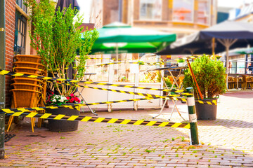 Indoor street cafe with inverted chairs in the center city