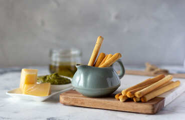 Grissini Italian crunchy breadsticks made of rice flour, parmesan cheese, pesto sauce and olive oil. Tasty snack