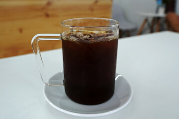 Close up glass cup of Iced black Americano coffee
