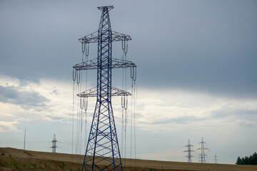   New high-voltage power tower with insulators and wires hanging freely on it.