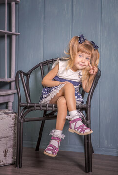 Portrait of little girl in retro vintage photographic studios.