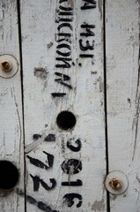 Old boards with white peeling paint with old inscription background