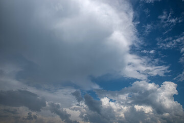 Naklejka na ściany i meble Dark thunderclouds on a blue sky.