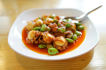 Spicy Stir-Fried Twisted cluster bean (Bitter bean or Stink bean) with scallop paste, Traditional Southern Thai food recipe, Popular in Thailand.