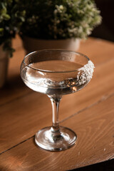 cold refreshing cocktail on a wooden table on a summer sunny day