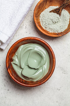 Clay mask in wooden bowl, top view. Skincare concept.