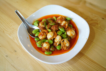 Spicy Stir-Fried Twisted cluster bean (Bitter bean or Stink bean) with scallop paste, Traditional Southern Thai food recipe, Popular in Thailand.