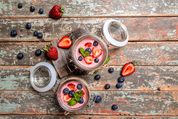 dessert panna cotta with mousse Greek yogurt or cream dessert with fresh strawberry blueberries. banner menu recipe top view.