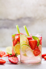 Detox sassy water with strawberries and lime in glasses. Healthy eating concept.