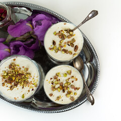 Traditional arabic dessert Ash Asaray. International cuisine. Toasted bread with whipped cream and pistachios.