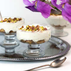 Traditional arabic dessert Ash Asaray. International cuisine. Toasted bread with whipped cream and pistachios.