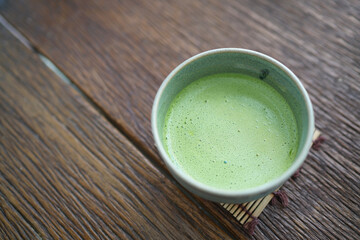 Hot Matcha - A bowl of green tea latte on wooden table and copy space, Traditional Japanese drink, Famous drink in japan.