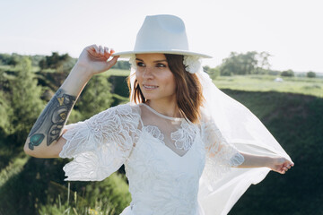 bride in white dress standing in green area