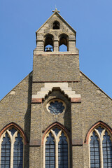 Fototapeta na wymiar The weathered stone exterior of St Mary Magdalene Church of England church on Trinity Road near Wandsworth Common, London. Image has copy space.
