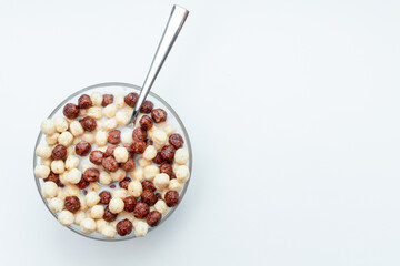 Breakfast chocolate cereal bowl with milk for morning eating. full of white and dark chocolate crispy food.