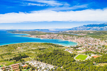 Croatia, panorama of the beautiful Adriatic sea coastline and town of Novalja on the island of Pag, view from drone