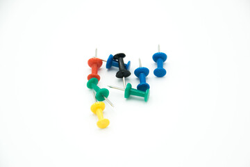 colored pushpins on a white background
