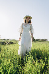 bride in white dress standing in green area