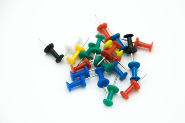 colored pushpins on a white background