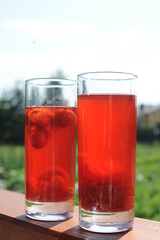 Traditional European non-alcoholic fruit beverage compote made from strawberries and rhubarb in summer