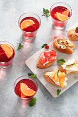 Fruit bruschetta with summer drink top view. Delicious appetizer, snack. Party time concept