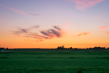 Beautiful pink colored cirrus clouds over the dutch countryside during the period of the longest days