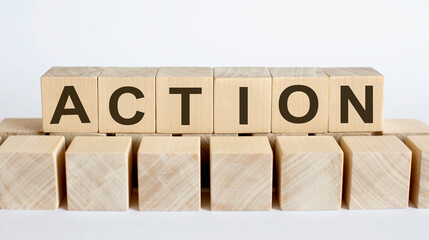 ACTION word from wooden blocks on desk, search engine optimization concept