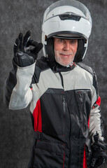portrait of senior biker with white helmet make OK