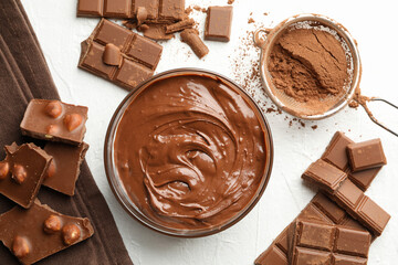 Chocolate, melted chocolate and powder on white background
