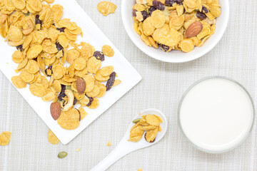Cornflakes on a white plate and fresh milk, placed for breakfast