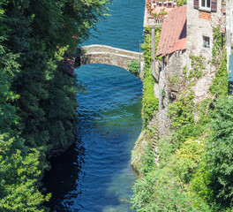 Fototapeta na wymiar medieval stone arch bridge. Nesso - Italy, tourist resort of Como Lake.